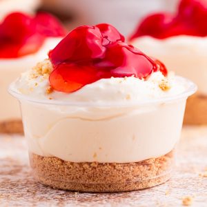 Cherry Cheesecake Shots 🍒✨ The perfect no-bake party dessert! Made with cheesecake pudding, Cool Whip, RumChata, graham crackers, and cherry pie filling. Easy dessert shooters for holidays, girls’ night, brunch, and celebrations. Try this simple make-ahead dessert idea!