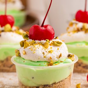 These creamy Pistachio Pudding Shots are the cutest party dessert! Made with pistachio pudding mix, RumChata, Cool Whip, and graham cracker topping. Perfect for holiday parties, girls’ night, St. Patrick’s Day treats, and easy no-bake desserts. Save this RumChata pudding shot recipe!