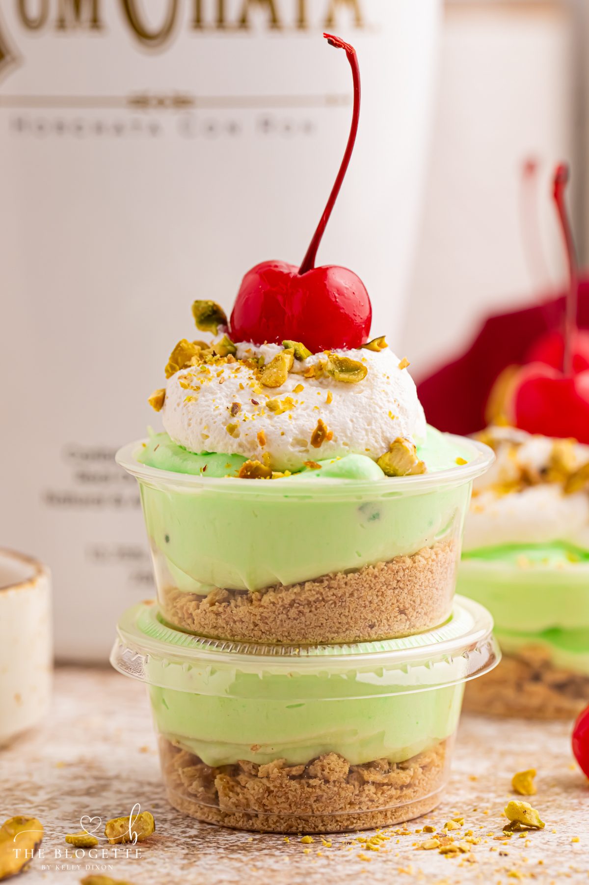 These creamy Pistachio Pudding Shots are the cutest party dessert! Made with pistachio pudding mix, RumChata, Cool Whip, and graham cracker topping. Perfect for holiday parties, girls’ night, St. Patrick’s Day treats, and easy no-bake desserts. Save this RumChata pudding shot recipe!