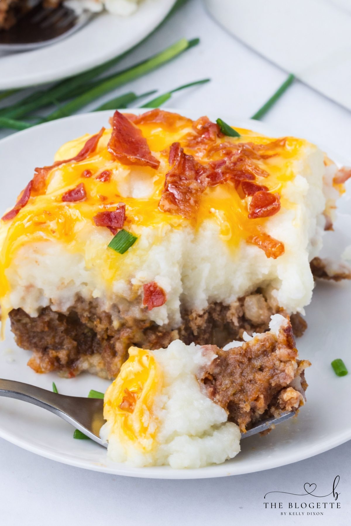 This Loaded Potato Meatloaf Casserole is the ultimate comfort food dinner. Layers of juicy meatloaf, creamy mashed potatoes, melted cheese, and crispy bacon make this easy casserole perfect for family dinners, meal prep, and freezer meals.