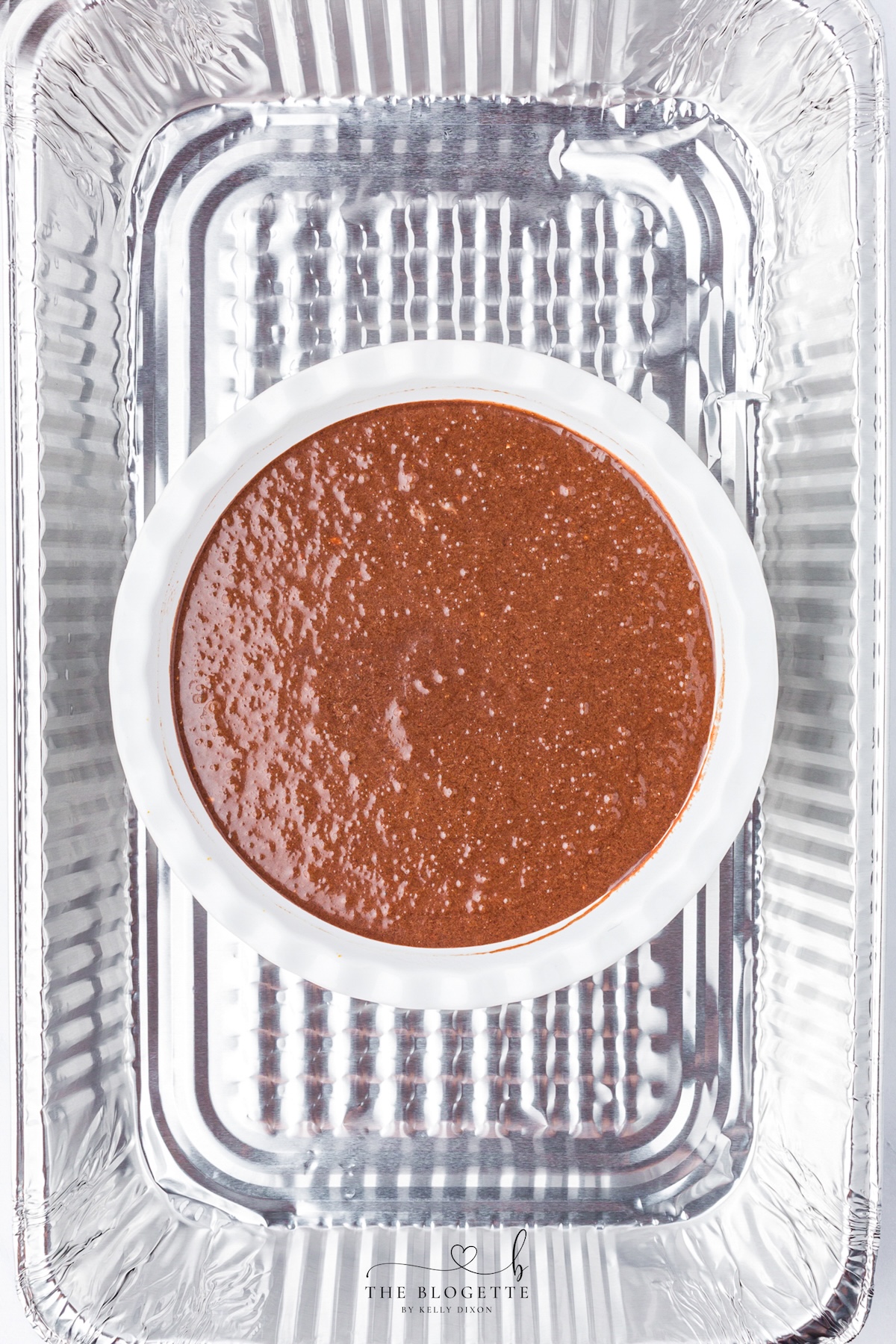 Place the pie pan inside a larger baking dish