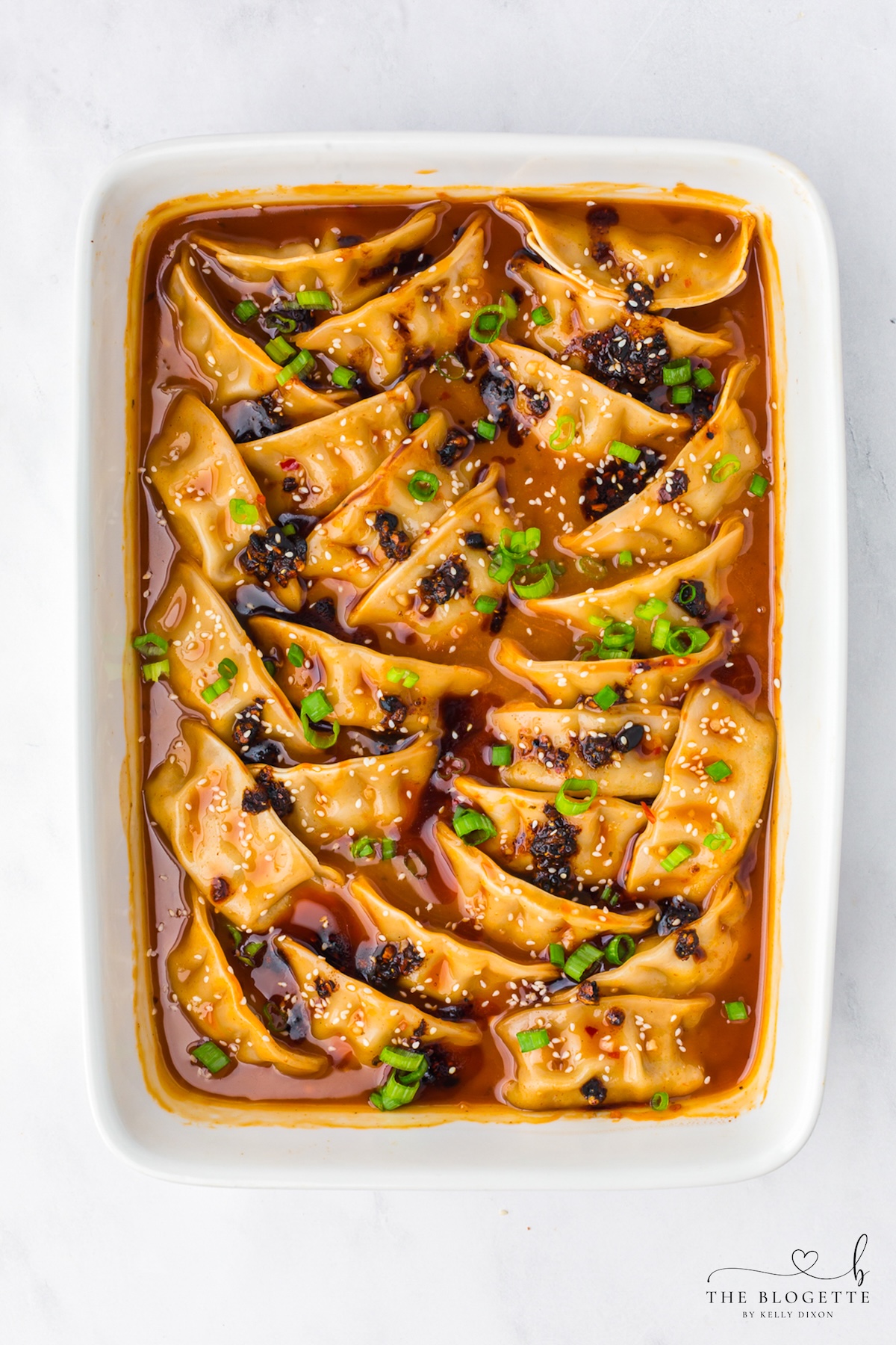 Chicken potstickers baked in creamy coconut red curry sauce
