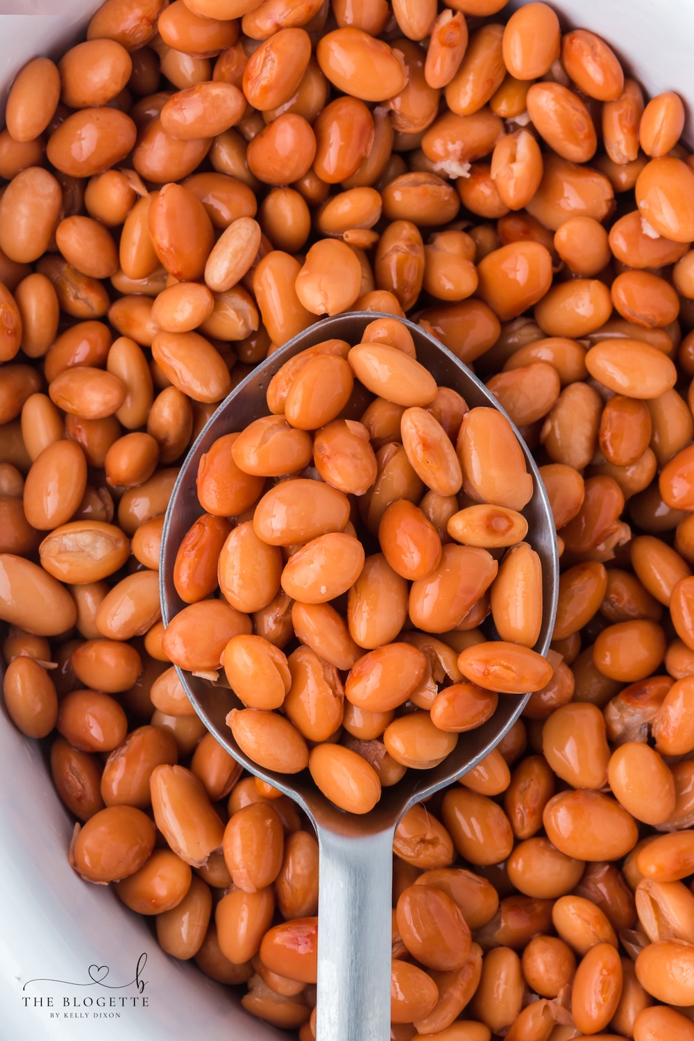 Learn how to make tender beans in the Crock Pot with only two ingredients and no soaking! These easy slow cooker pinto beans are perfect for tacos, soups, burritos, casseroles, meal prep, and freezer-friendly portions.