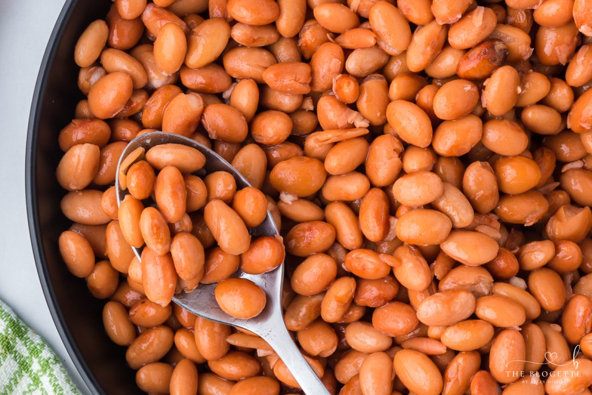 Learn how to make tender beans in the Crock Pot with only two ingredients and no soaking! These easy slow cooker pinto beans are perfect for tacos, soups, burritos, casseroles, meal prep, and freezer-friendly portions.