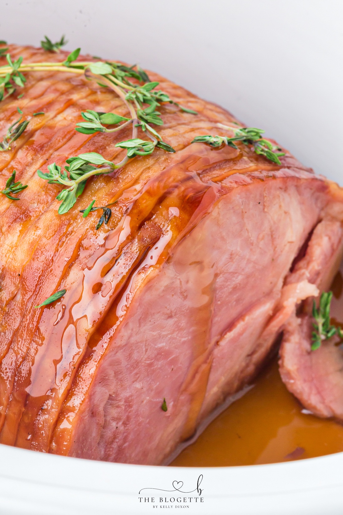 Make tender Crock Pot Ham with a maple brown sugar glaze, pineapple juice, butter, and thyme. An easy holiday ham recipe made in the slow cooker!