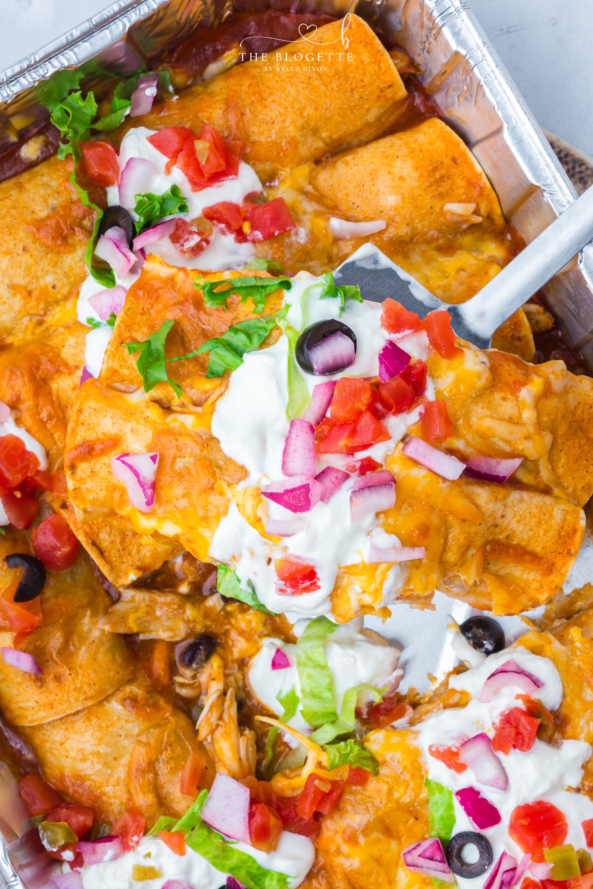 These Freezer Chicken Enchiladas make busy-night dinners so much easier! Crockpot chicken, black beans, green chiles, red enchilada sauce, and plenty of melted cheese come together in a recipe that makes TWO pans. Bake one tonight and freeze one for later!