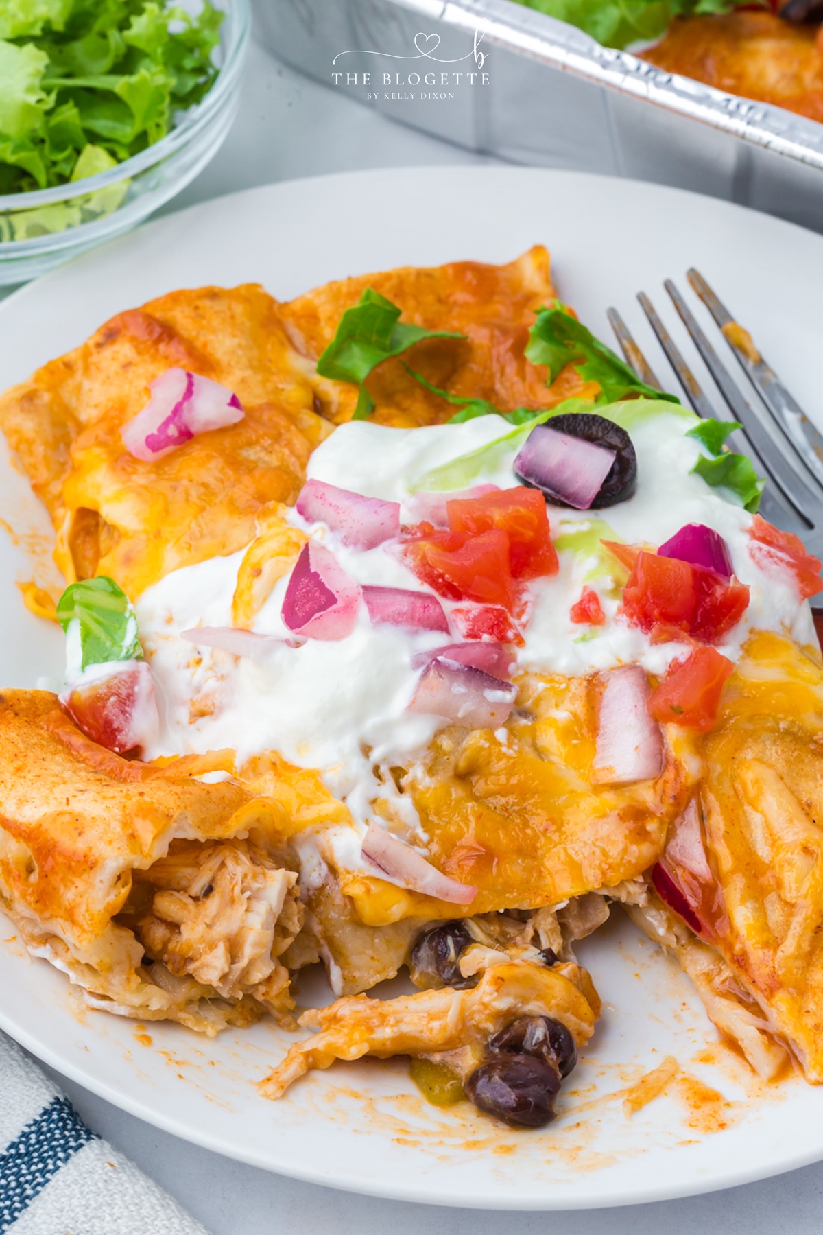 These Freezer Chicken Enchiladas make busy-night dinners so much easier! Crockpot chicken, black beans, green chiles, red enchilada sauce, and plenty of melted cheese come together in a recipe that makes TWO pans. Bake one tonight and freeze one for later!